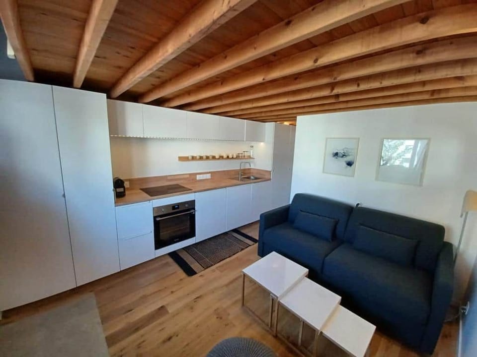 Cuisine avec nombreux équipements (plaques, four, mini-réfrigérateur, cafetière Nespresso, lave-vaisselle) et nombreux rangements.