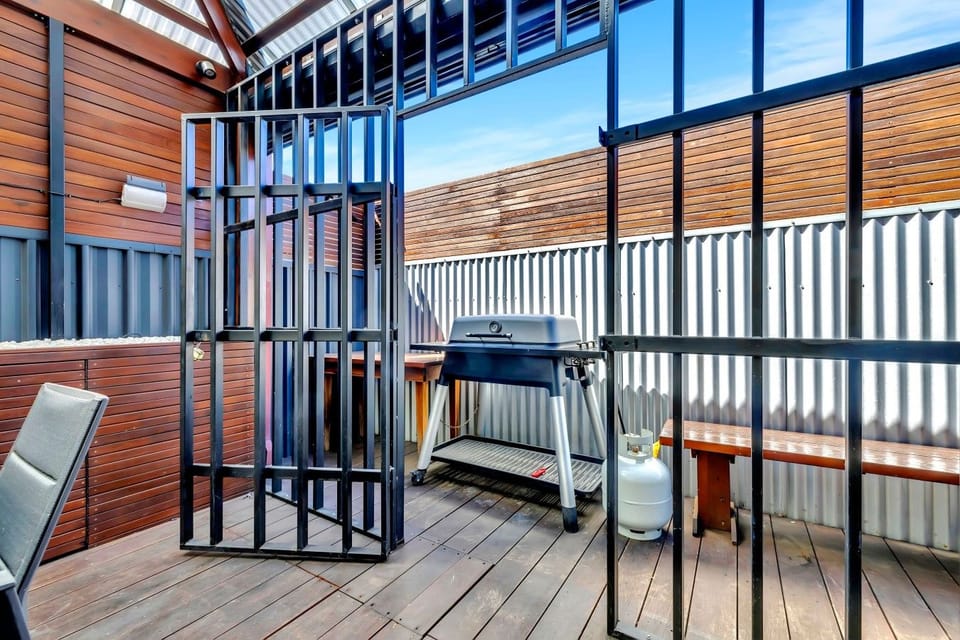 Private outdoor cooking space with corrugated iron surrounds.
