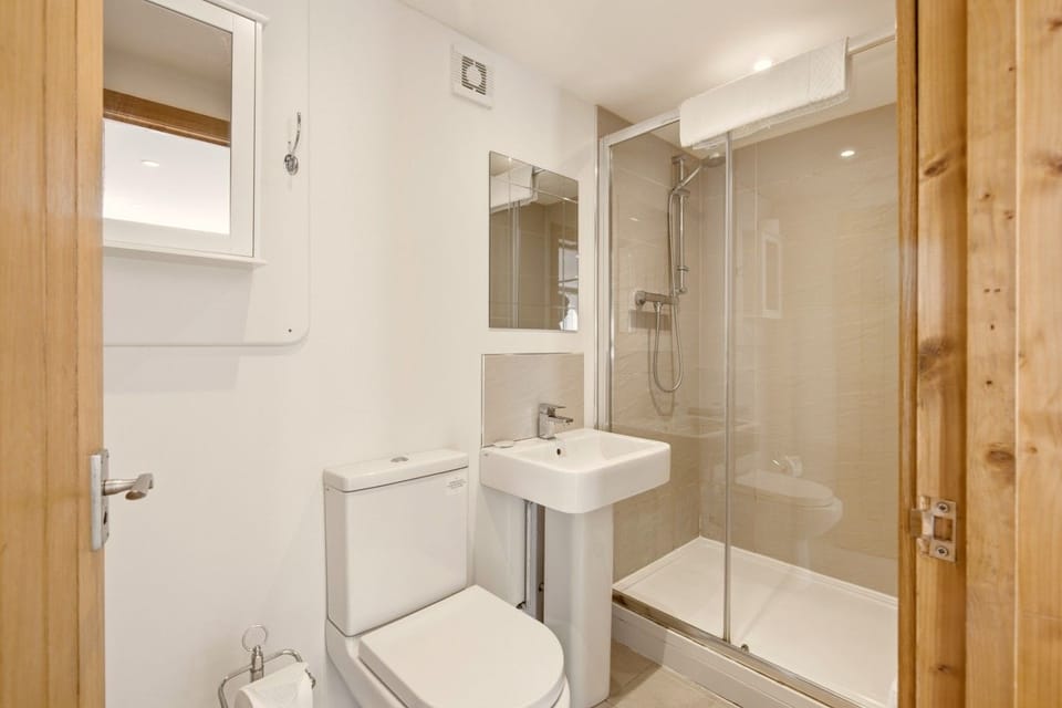 Shower room with glass enclosure, wash basin and WC