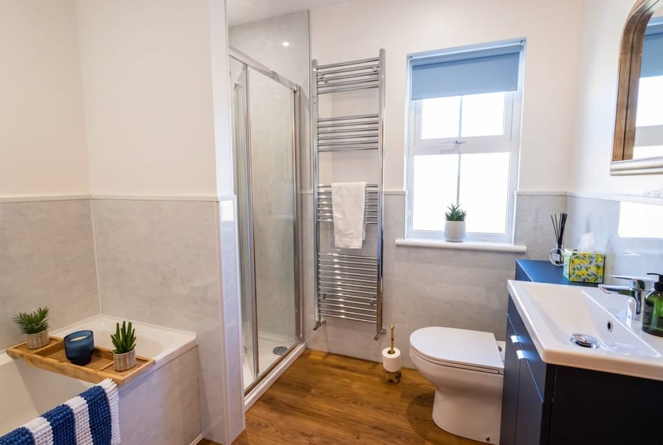 The family bathroom has both a bath and a walk-in shower.