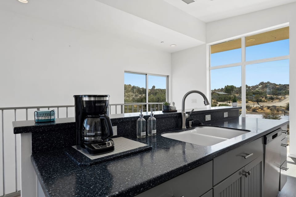 Start your morning with a fresh cup of coffee while sunlight and desert views pour into the kitchen.