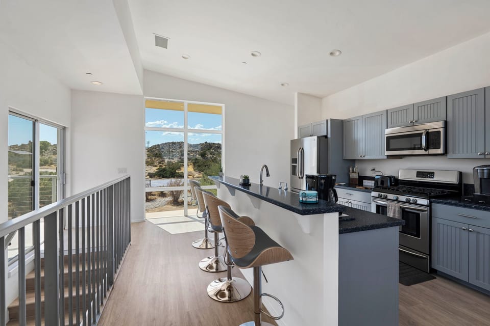 Cook, dine, and relax together in this bright open-concept space surrounded by beautiful desert views.