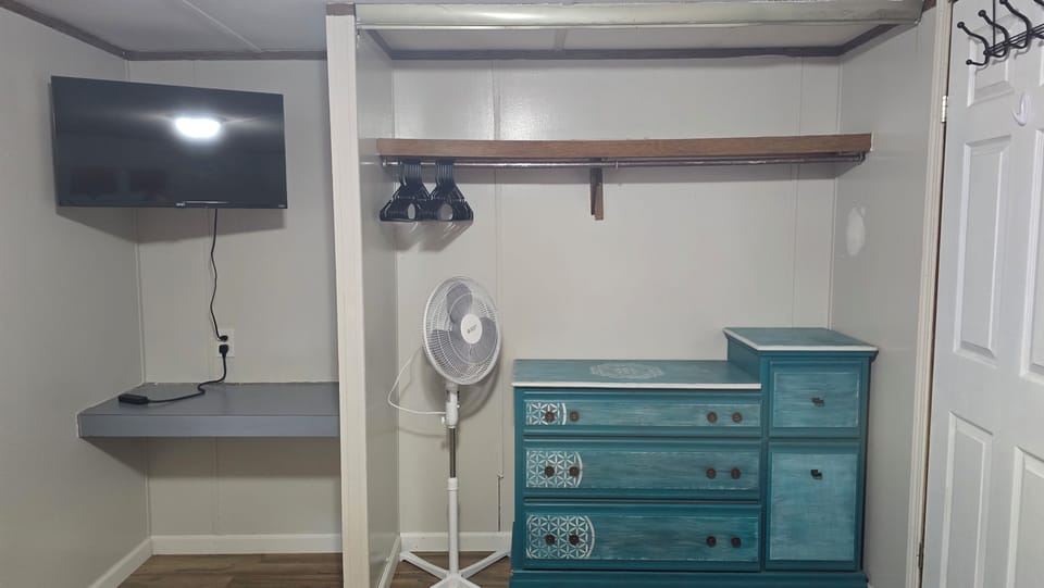 32 in tv. Fan. Hangers available. A few games and toys in the dresser.
