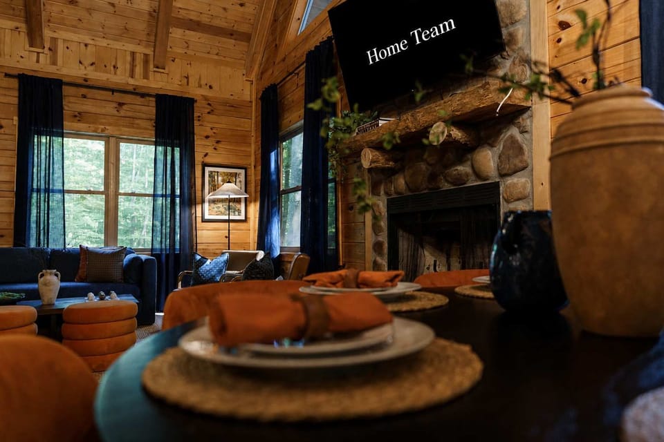 Settle in for game night by the stone fireplace, with a table set and ready to turn any evening into a shared meal with friends.