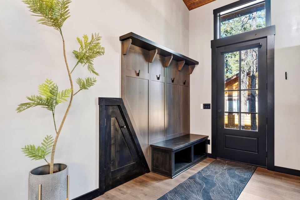 A welcoming entry with a convenient bench and hall tree makes settling into mountain time effortless.