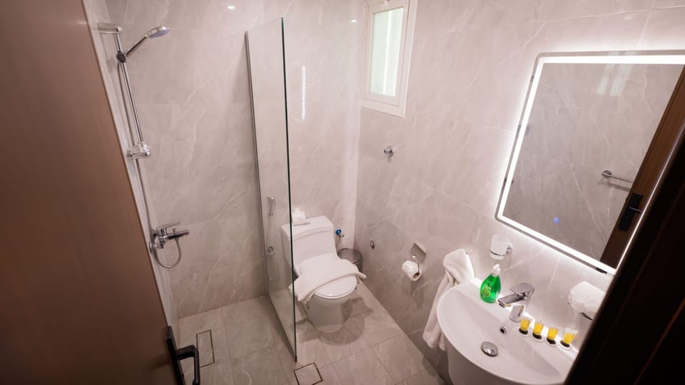 Standard Double Room | Bathroom | Shower, slippers, towels, soap