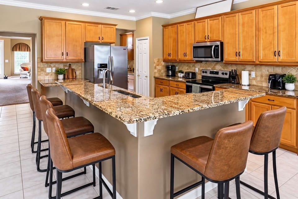 Large, open kitchen area designed for easy meal prep with premium appliances and elegant wood finishes.
