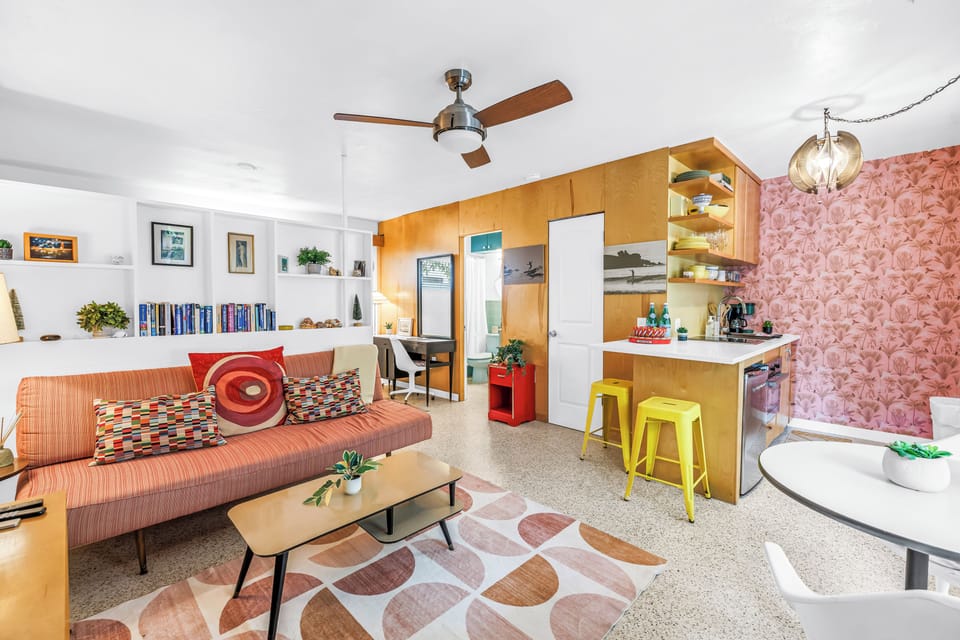 Bright retro-modern living space with cozy seating and stylish breakfast bar