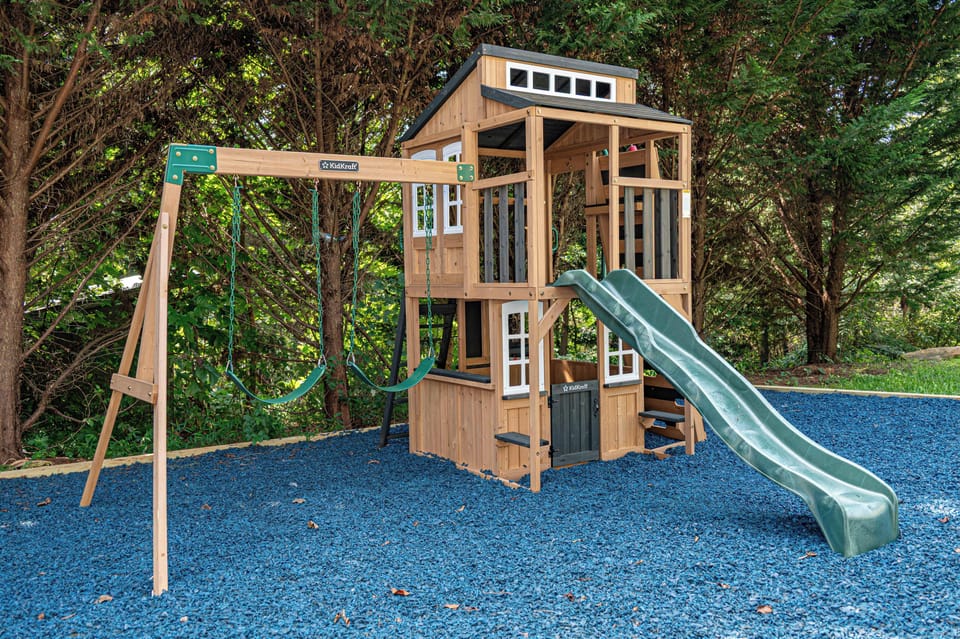 The kids will love the playset while the adults play some corn hole!