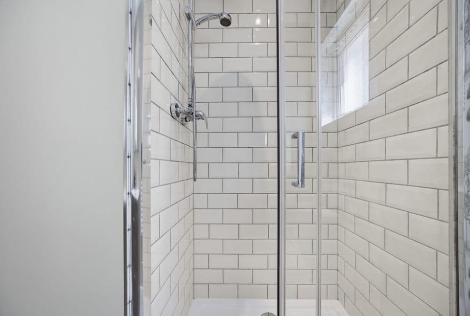 Clean, tiled shower enclosure in the bathroom.
