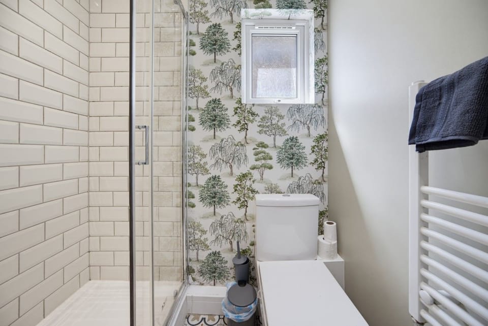 Step into the bright tiled shower.