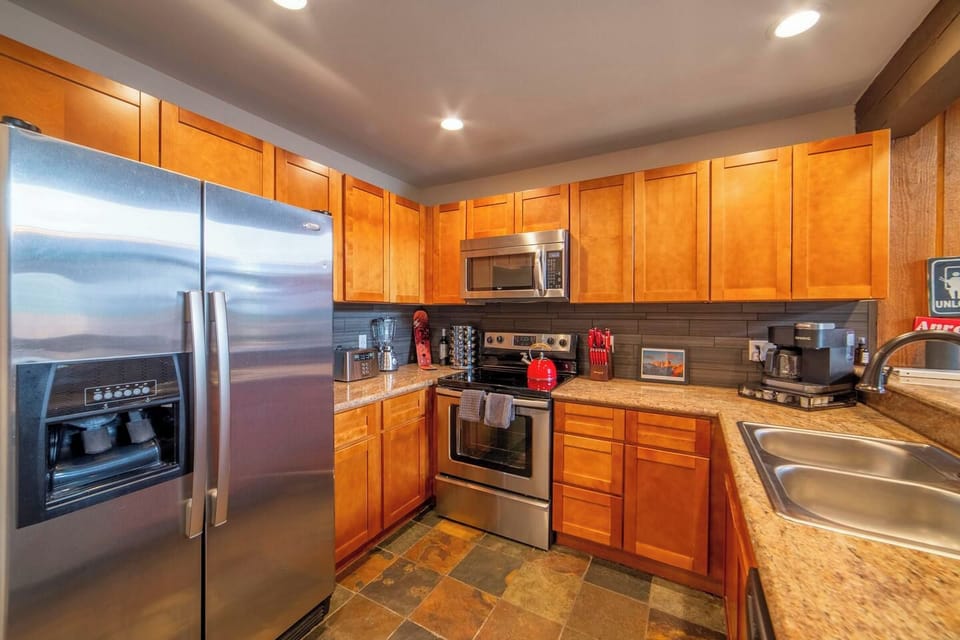 Kitchen with granite counters and stainless appliances is stocked with all the equipment to whip up amazing meals.  Keurig with coffee and tea. Filtered water, seasonings, and basic condiments are stocked and awaiting your stay. 