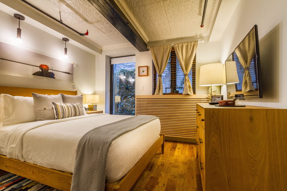 Deluxe Loft Suite with Patio (Lower Level) | Premium bedding, memory foam beds, in-room safe, desk