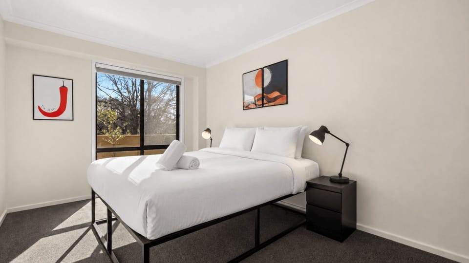 Comfortable bedroom with crisp linen and plenty of natural light.
