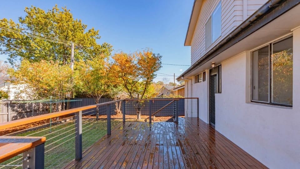 Elevated deck overlooking the leafy backyard
