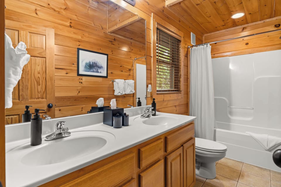 Room to get ready without competing for the mirror. This private ensuite features a double-sink vanity, bathtub and shower combination, fresh towels and Altespacio guest essentials.