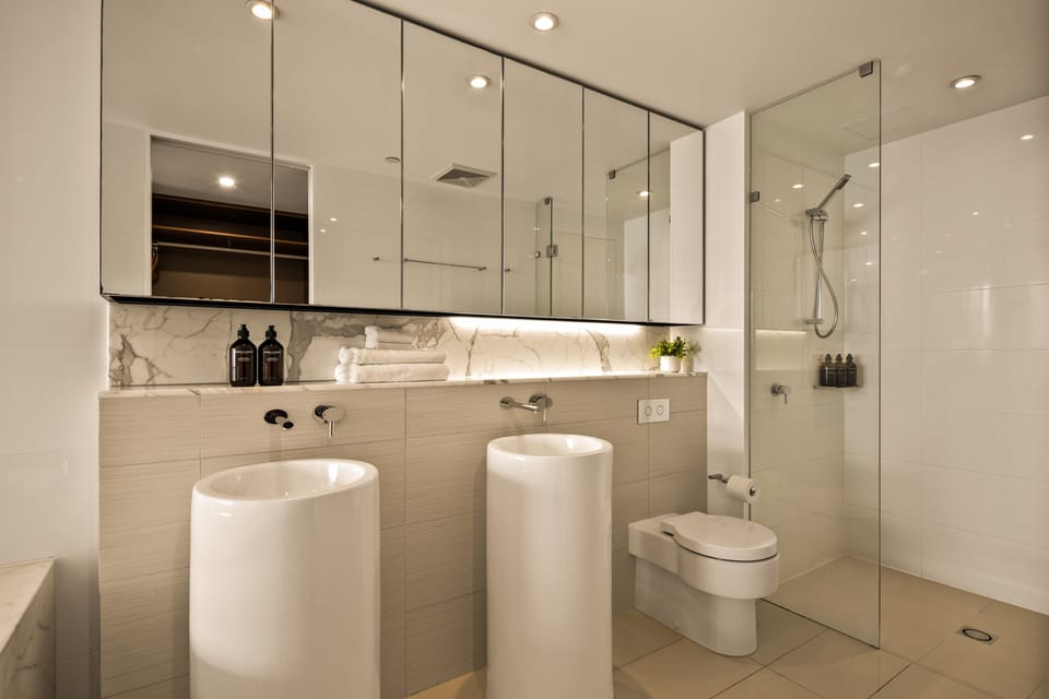 Ensuite with twin pedestal basins, walk-in shower and Grown Alchemist amenities