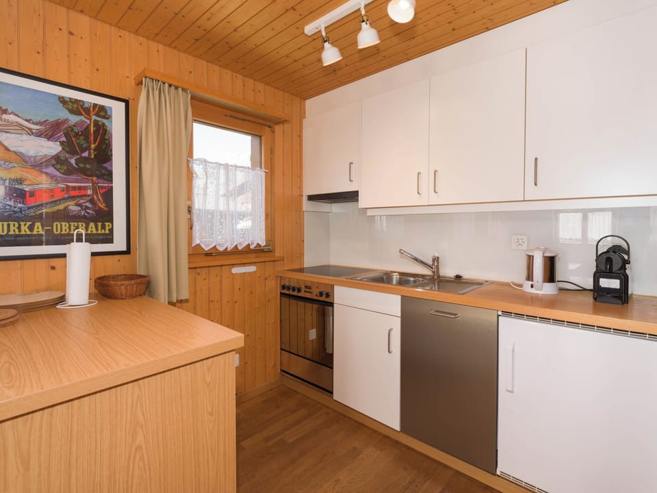 Fully equipped kitchen with dishwasher, coffee machine, and essential cooking facilities.
