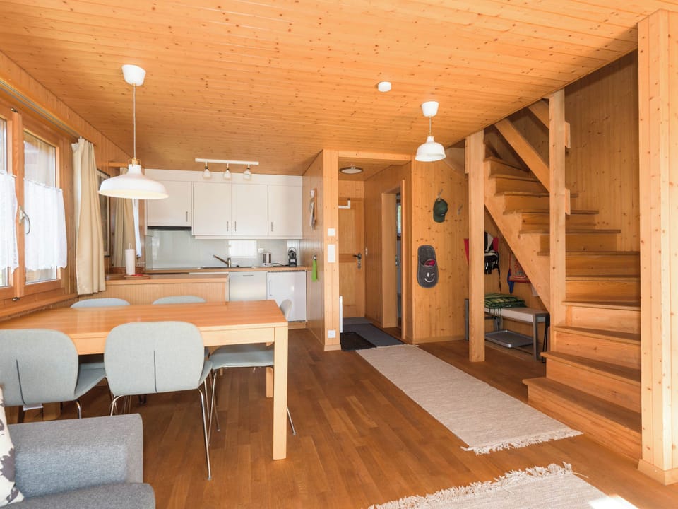 Dining and kitchen area with internal staircase leading to the upper floor of the duplex.
