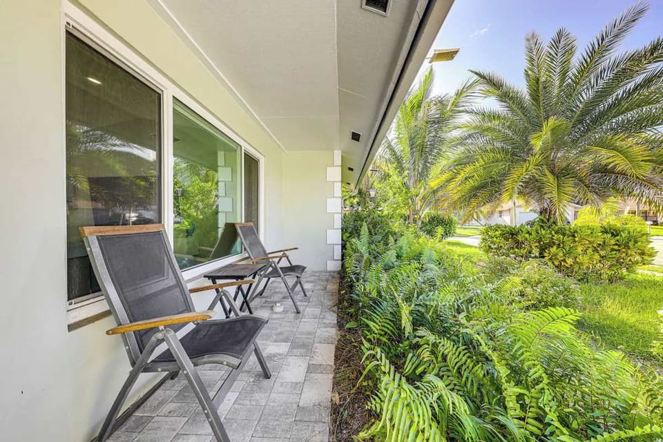 Covered seating surrounded by lush tropical landscaping