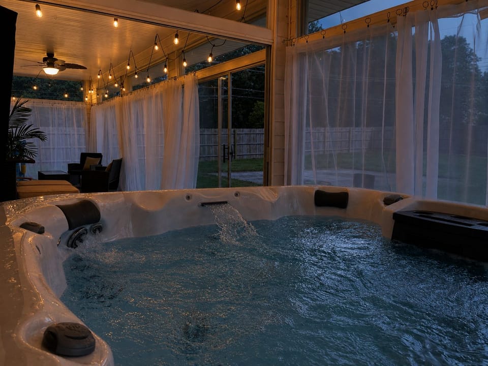 End your evening with a warm soak beneath glowing string lights ✨—the private hot tub feels especially inviting after sunset.