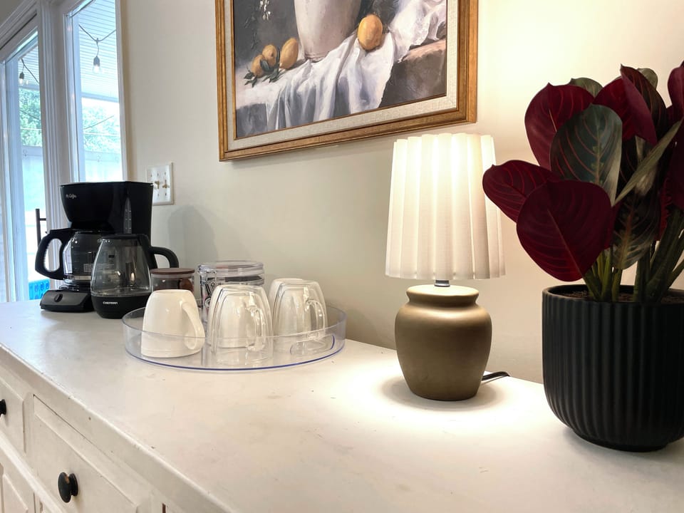 Start your morning at the dedicated coffee station ☕, complete with a drip coffeemaker, mugs, and glasses ready for your favorite brew.