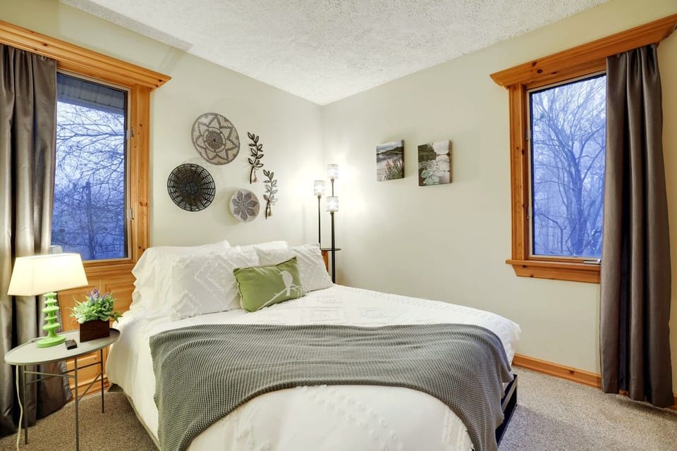 Wake up surrounded by the quiet beauty of the Poconos in this warm and inviting queen bedroom.