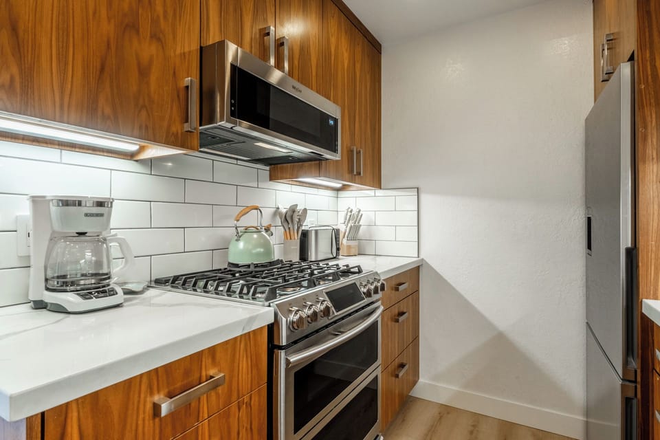 Your well-equipped kitchen features warm wood cabinetry, modern stainless steel appliances, and everything you need to prepare delicious home-cooked meals during your stay.