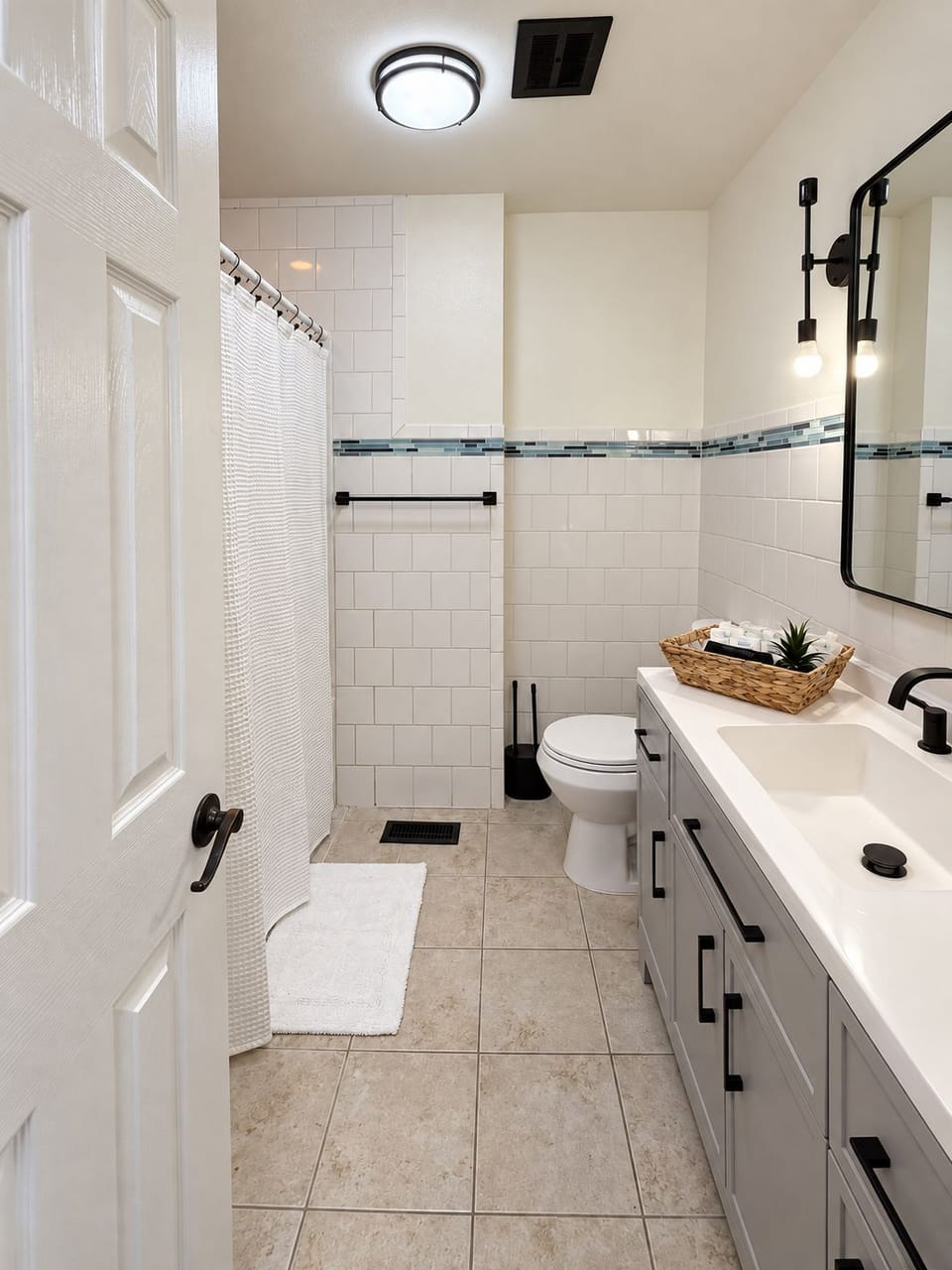 Bright modern bathroom with subway tile, sleek vanity, and stylish black fixtures