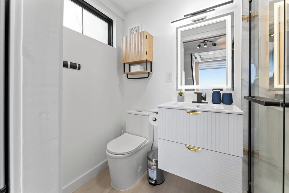 Bright modern bathroom with glass shower and stylish designer finishes