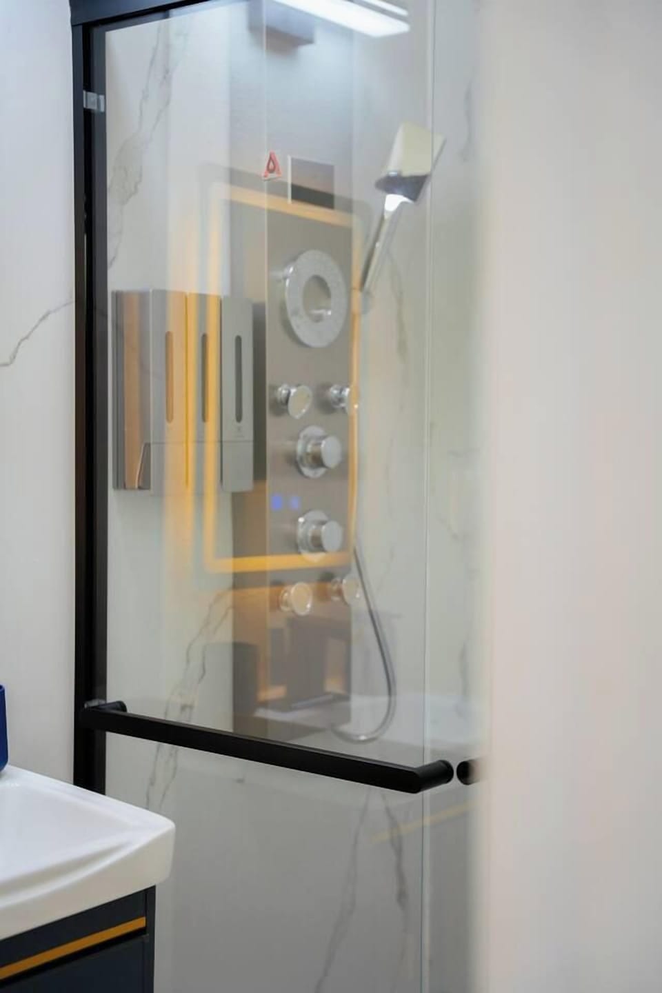 Spa-style glass shower with luxe multi-jet panel and modern finishes