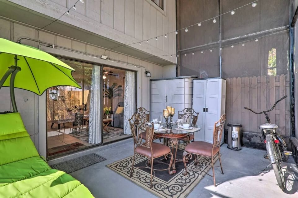Charming screened porch featuring a stylish outdoor dining set and vibrant green sun lounger, perfect for relaxed living and entertaining.