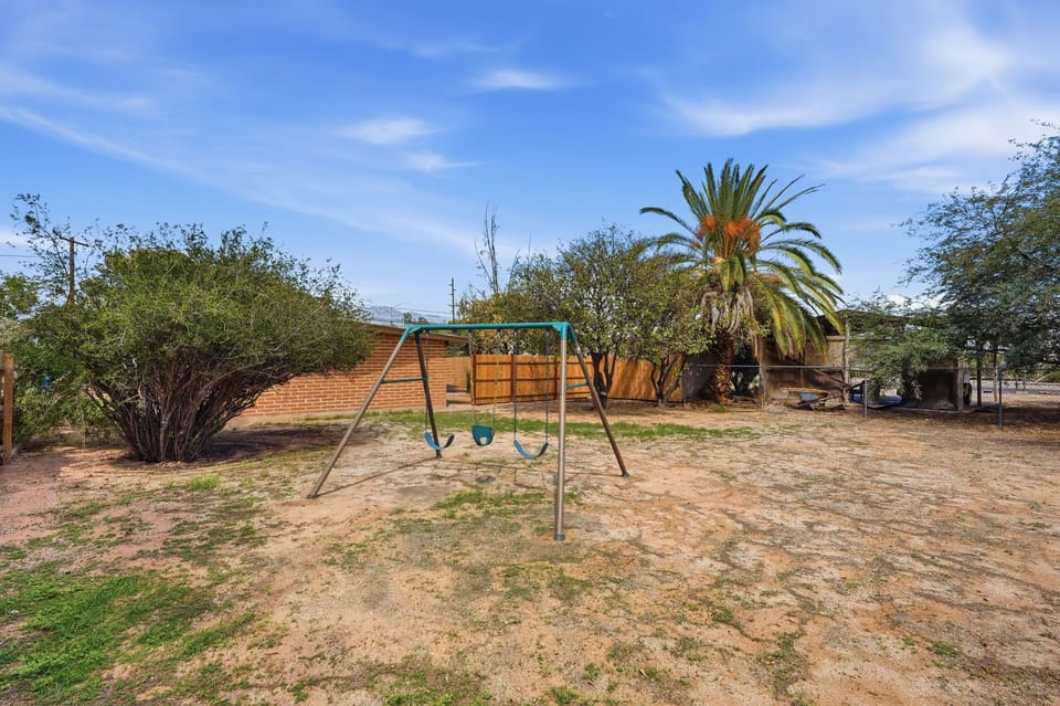 Kid-Friendly Play Space: Features a classic backyard swing set to keep the little ones entertained during your stay.