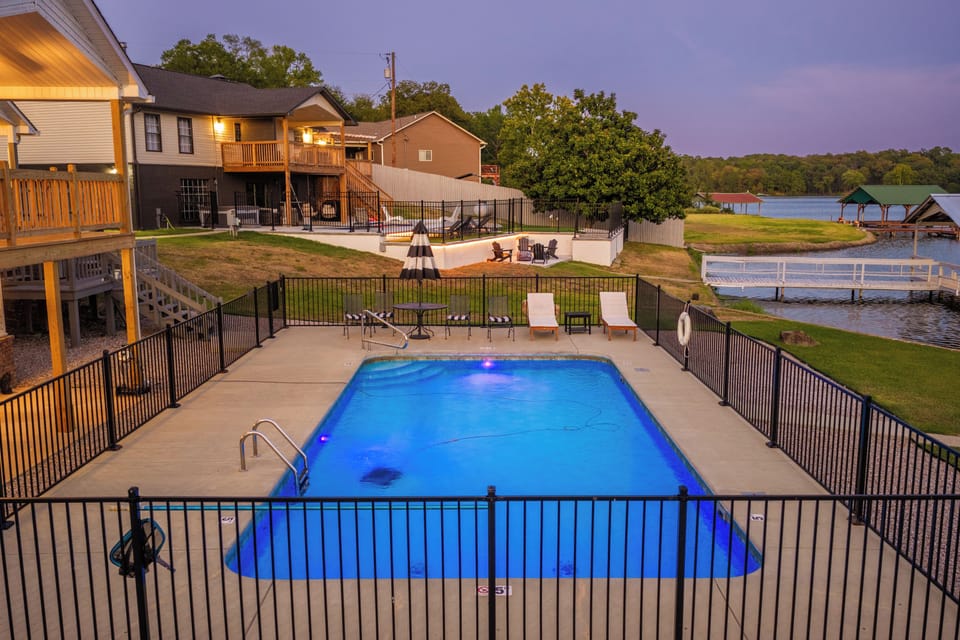 Private pool, lakefront views, and spacious outdoor living at dusk