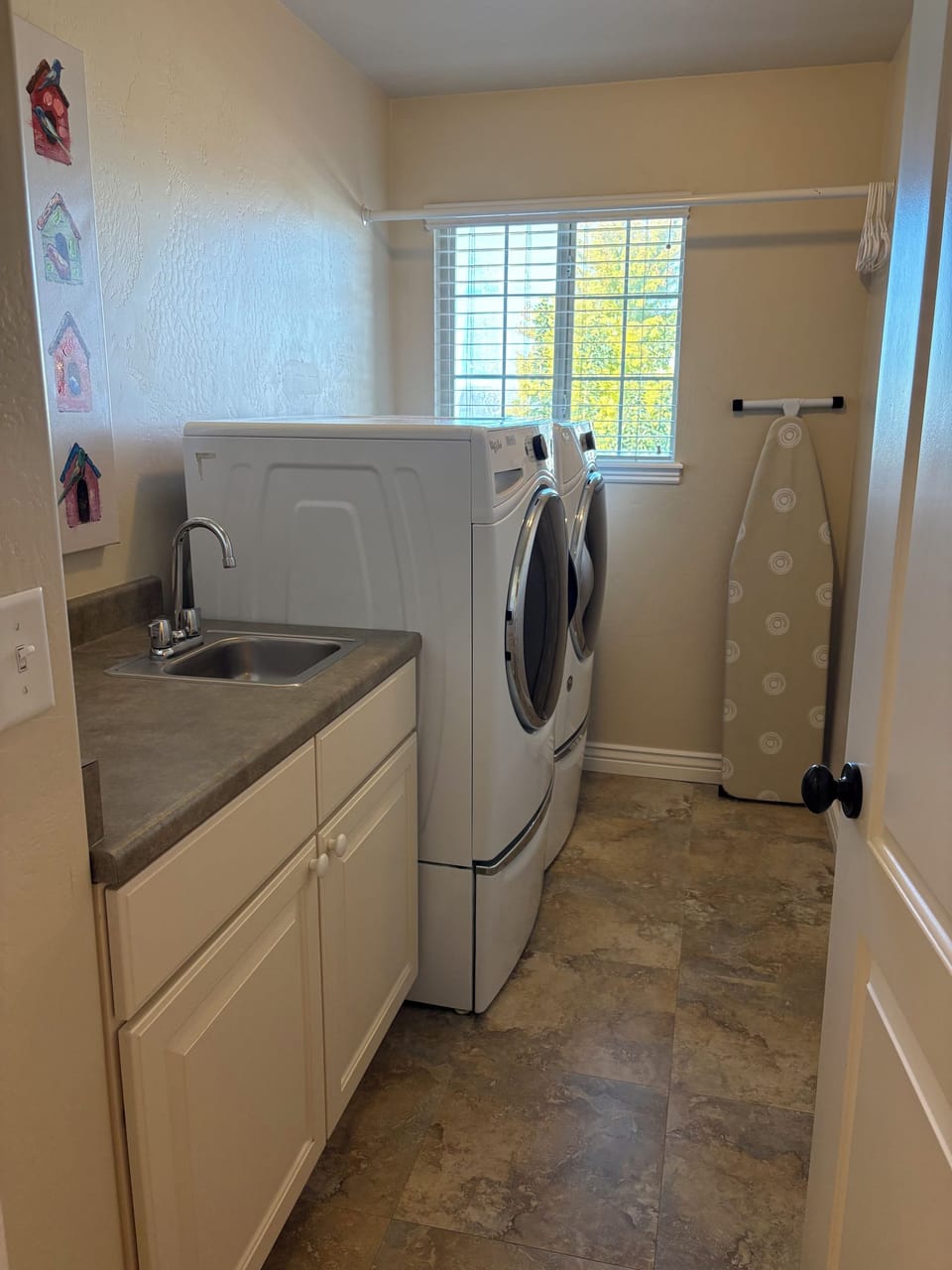 Laundry room with a washer, dryer, and utility sink