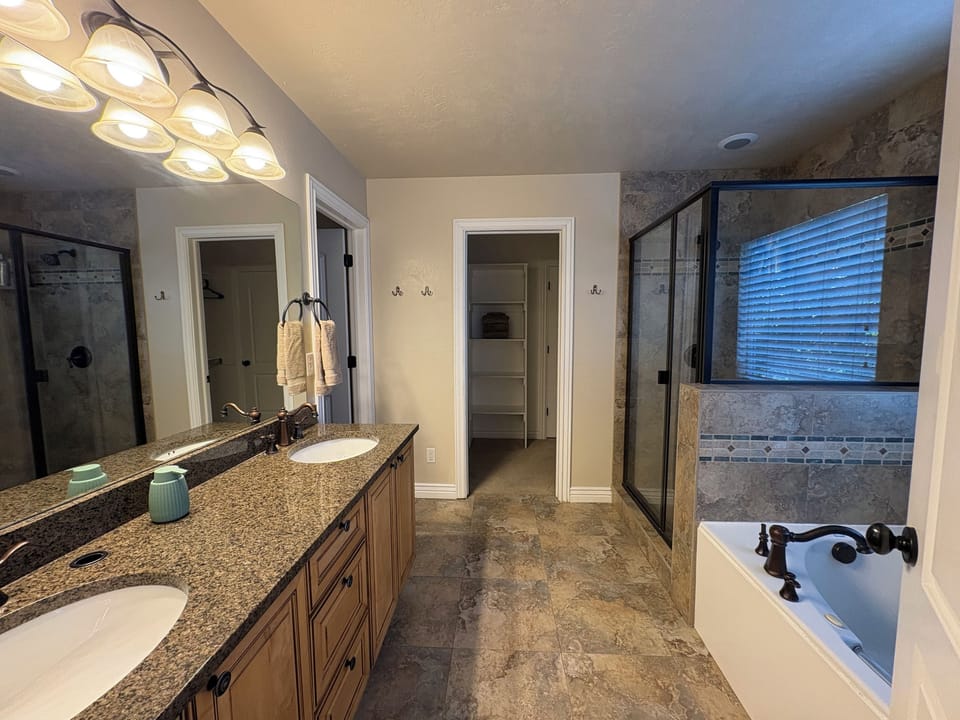 Primary bathroom with a soaking tub and glass shower
