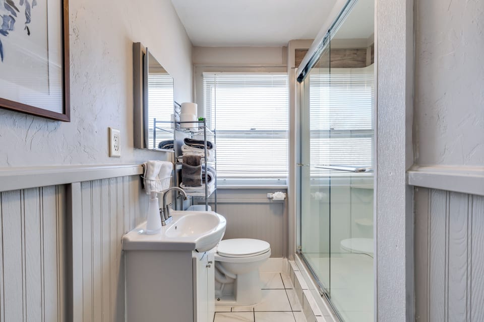 Bright bathroom with walk-in glass shower and natural light