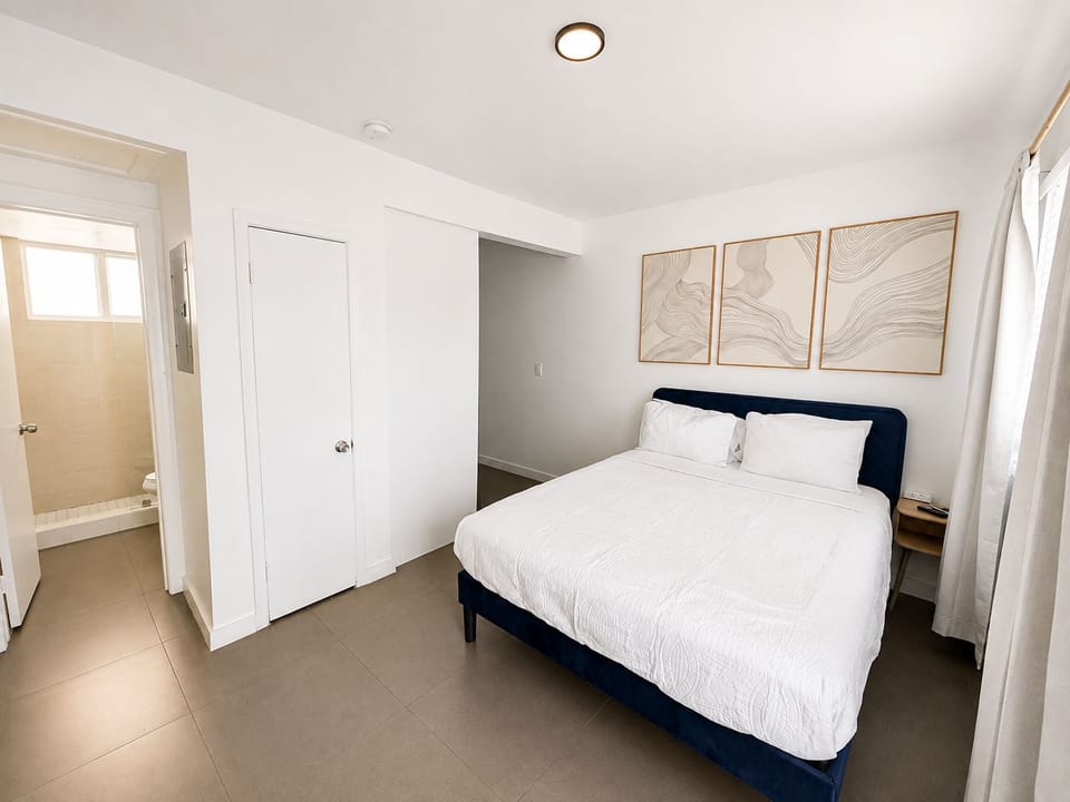 Bright modern bedroom with en suite bath and elegant minimalist design