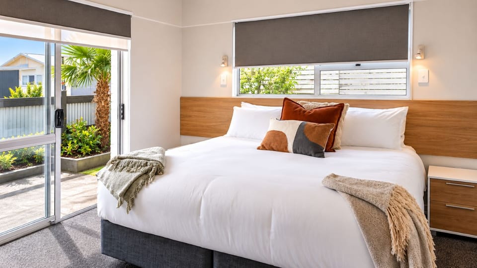 Bright, cozy bedroom with king bed and easy outdoor access