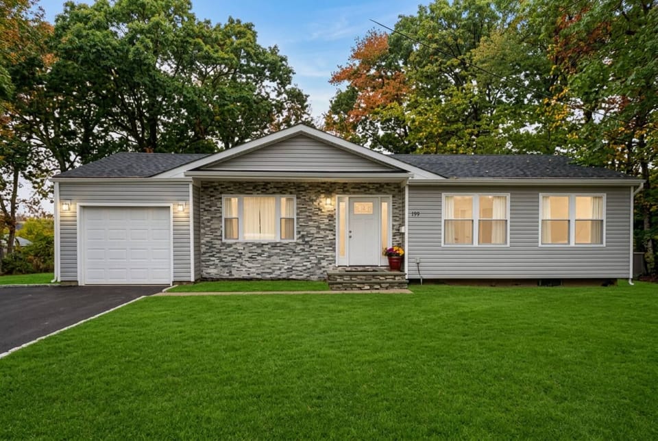 Charming single-story home with modern curb appeal and lush front lawn