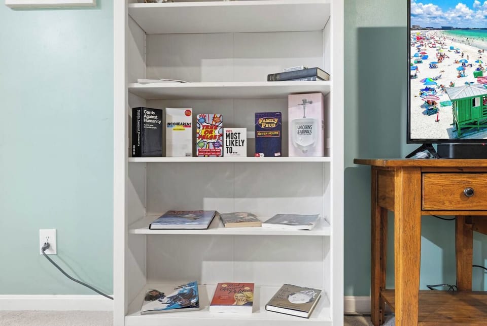 Game shelf and books for cozy, family-friendly indoor entertainment