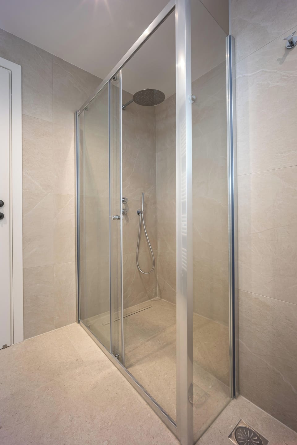 Walk-in shower with glass enclosure