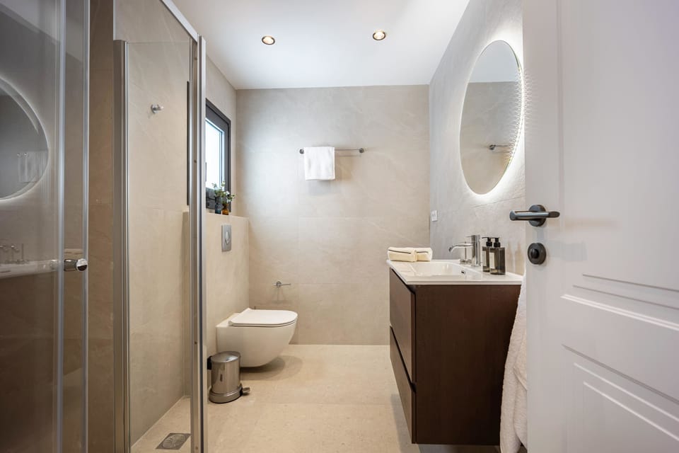 Contemporary bathroom with illuminated mirror
