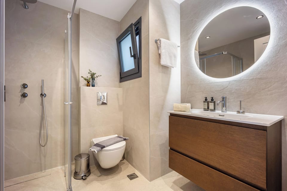 Contemporary bathroom with illuminated mirror