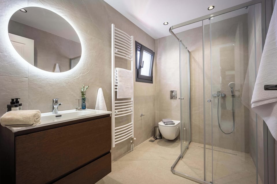 Contemporary bathroom with illuminated mirror