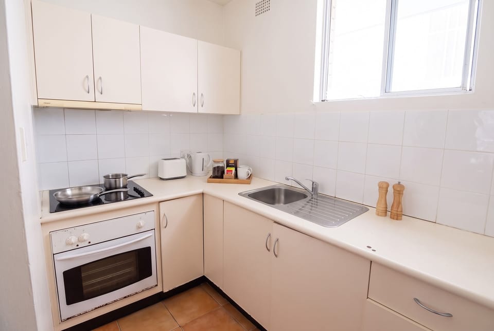 Kitchen with cooktop, oven, pans, salt and pepper