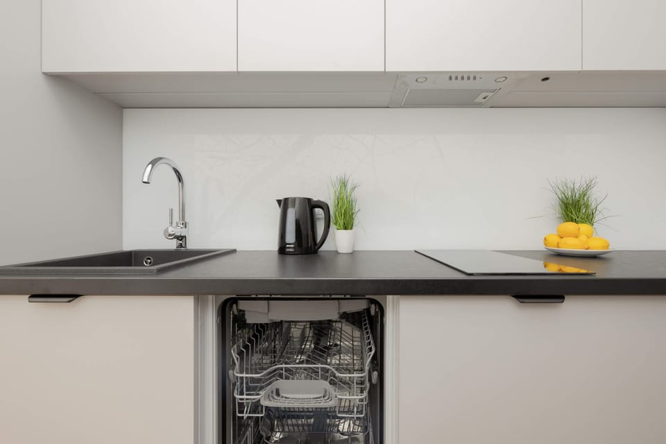 A washing machine conveniently placed in a dedicated corner, ensuring easy access for laundry needs.

