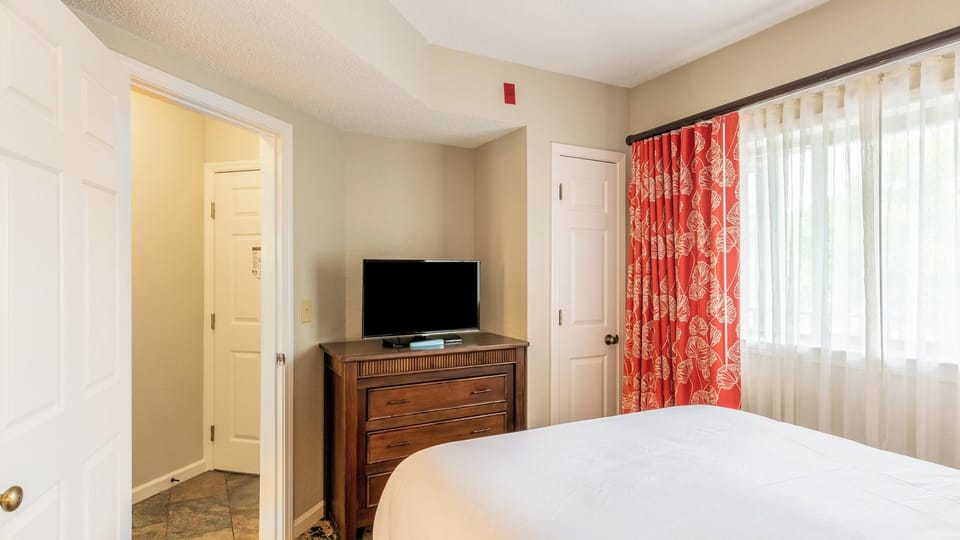 Primary Bedroom • Dresser with TV & Bathroom Access