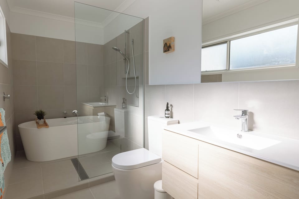 Bright spa-style bathroom with soaking tub and glass walk-in shower
