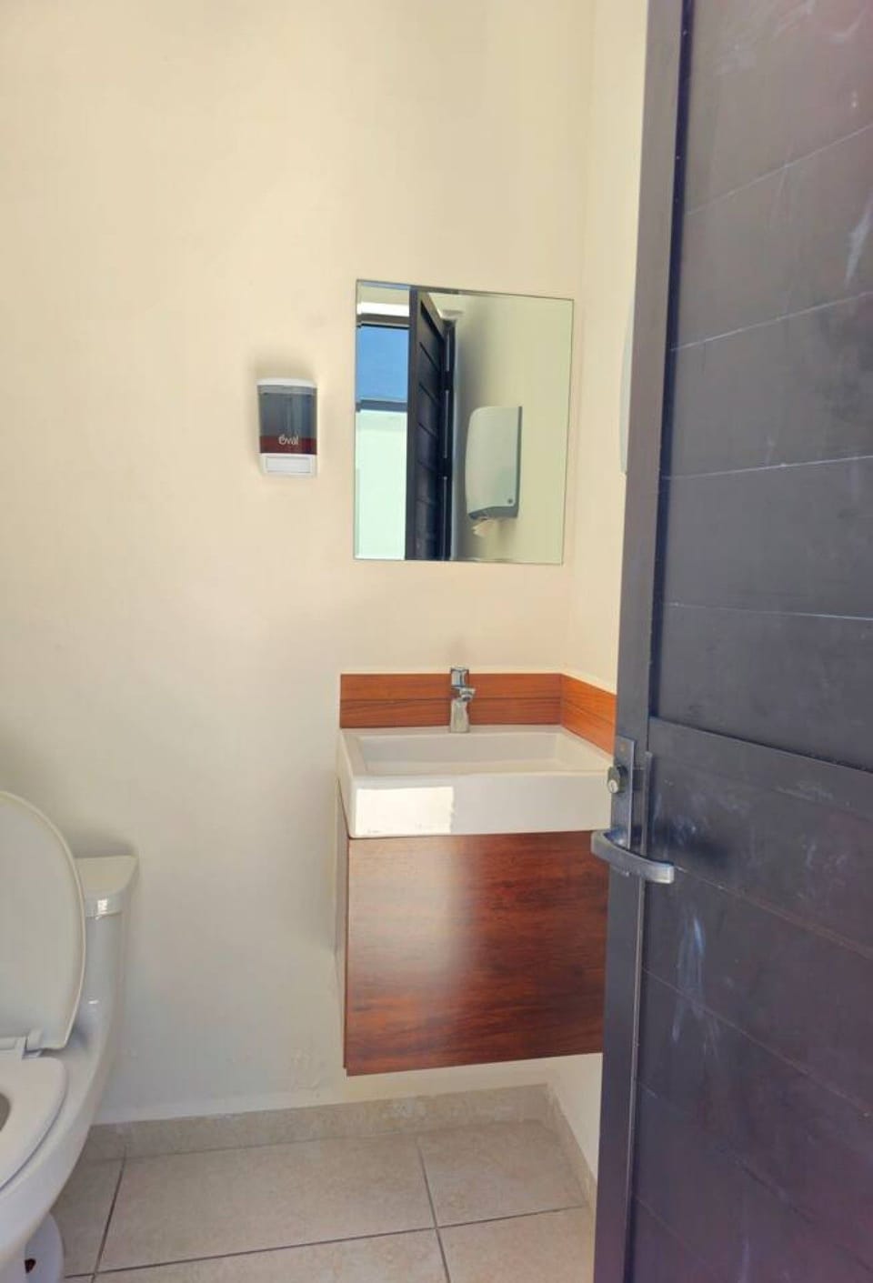 Modern bathroom vanity with a large mirror, sink and stylish contemporary finishes.